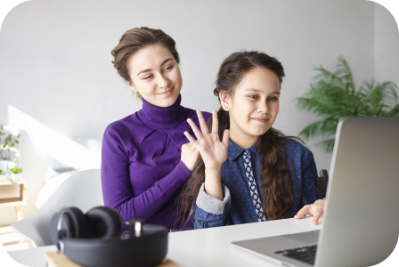 Two students waving during a live video lesson